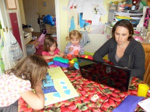 Clare Kirkpatrick writing at home with her girls
